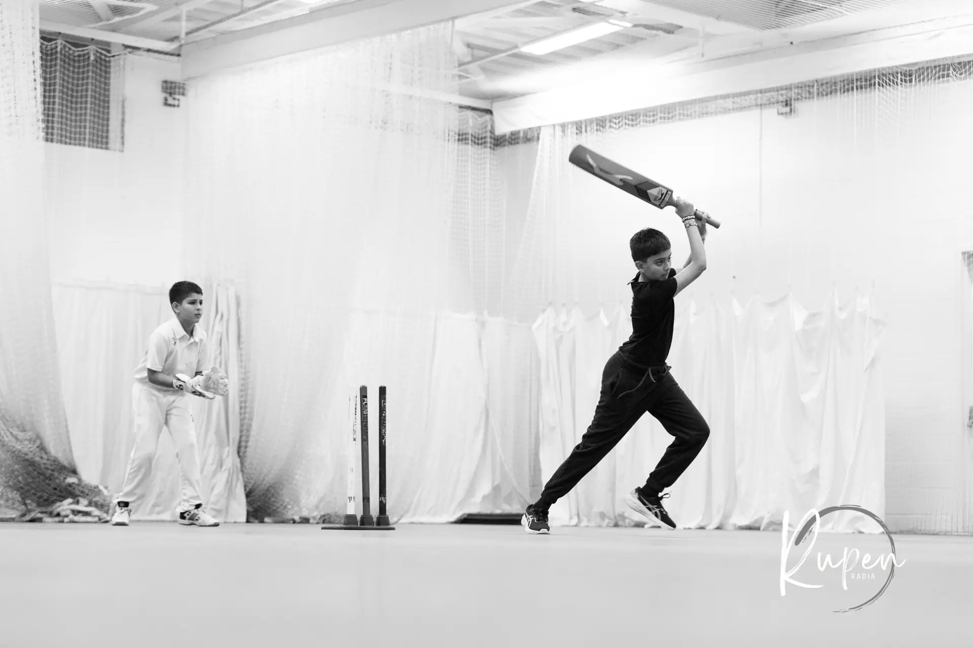 Young players batting in the indoor cricket nets at the Lohana Sports Festival 2025