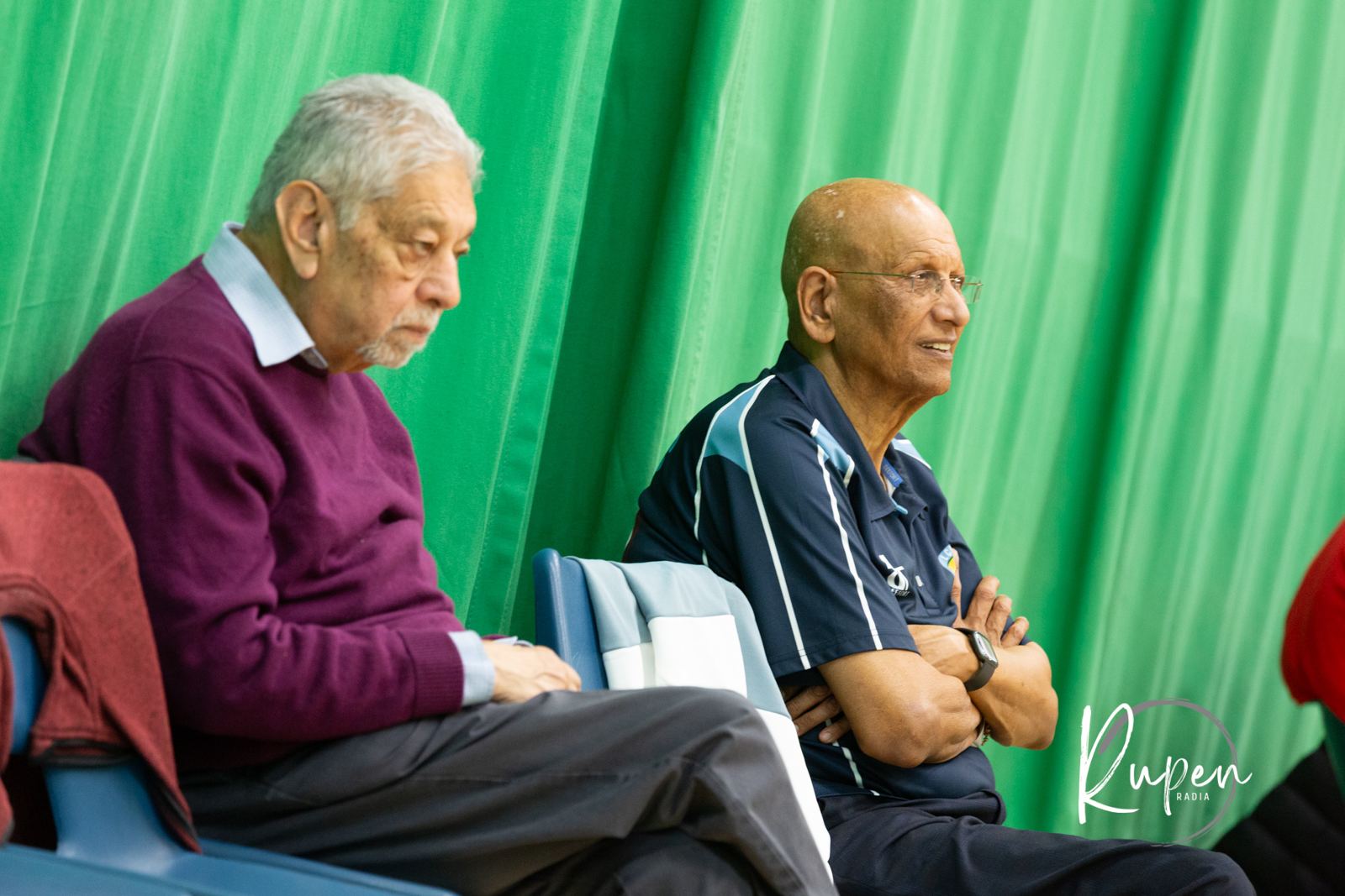 Two elders watching courtside
