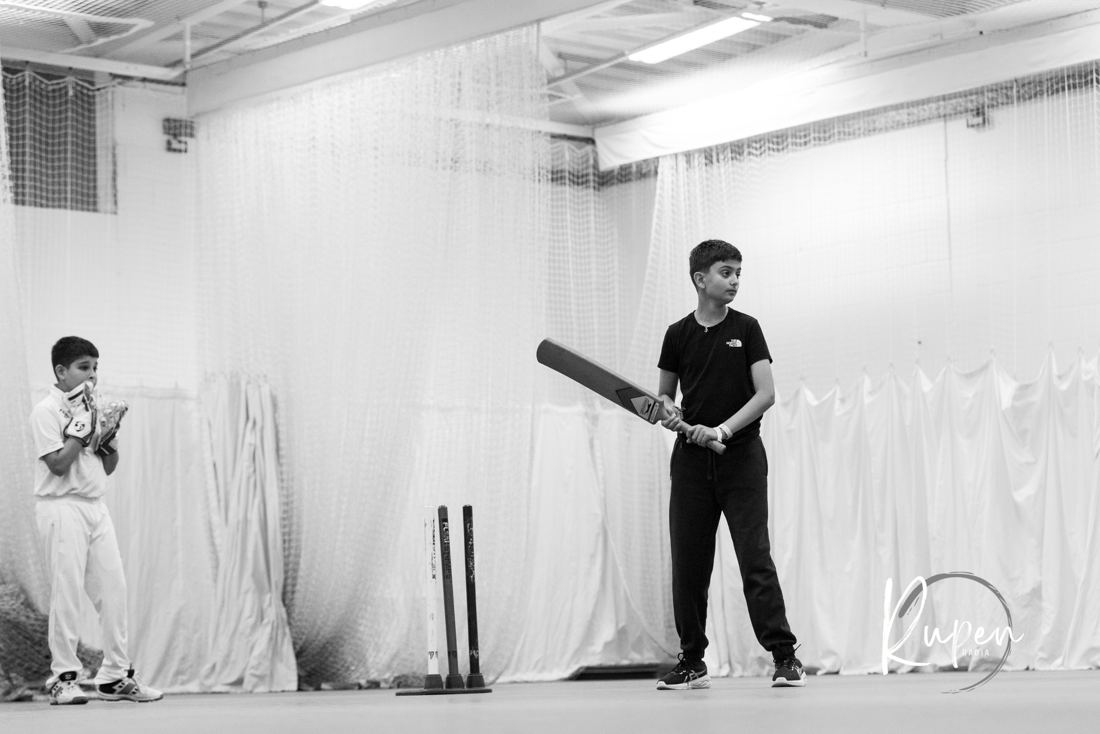 A young batter at the crease