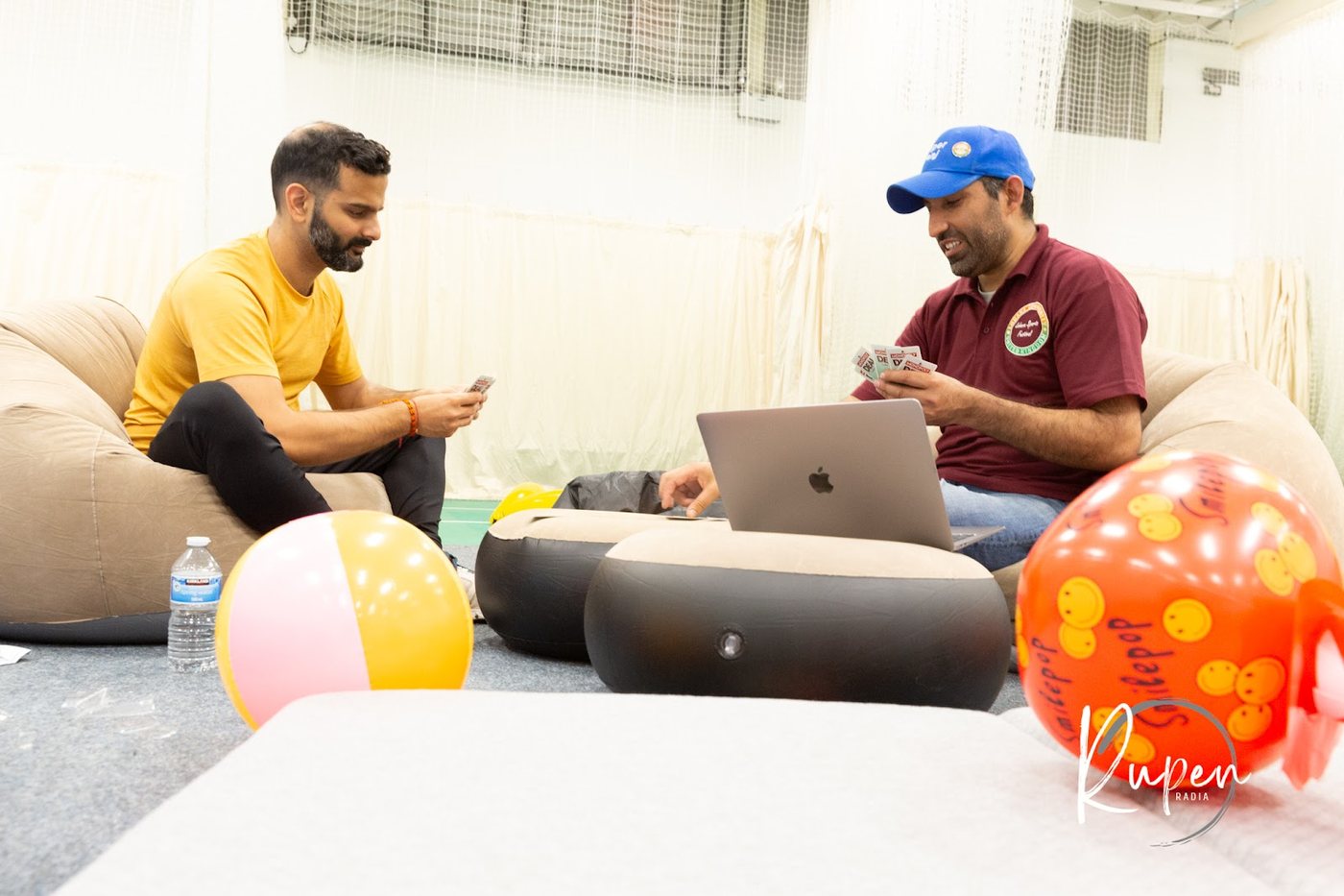 Two organisers working at a laptop behind the scenes