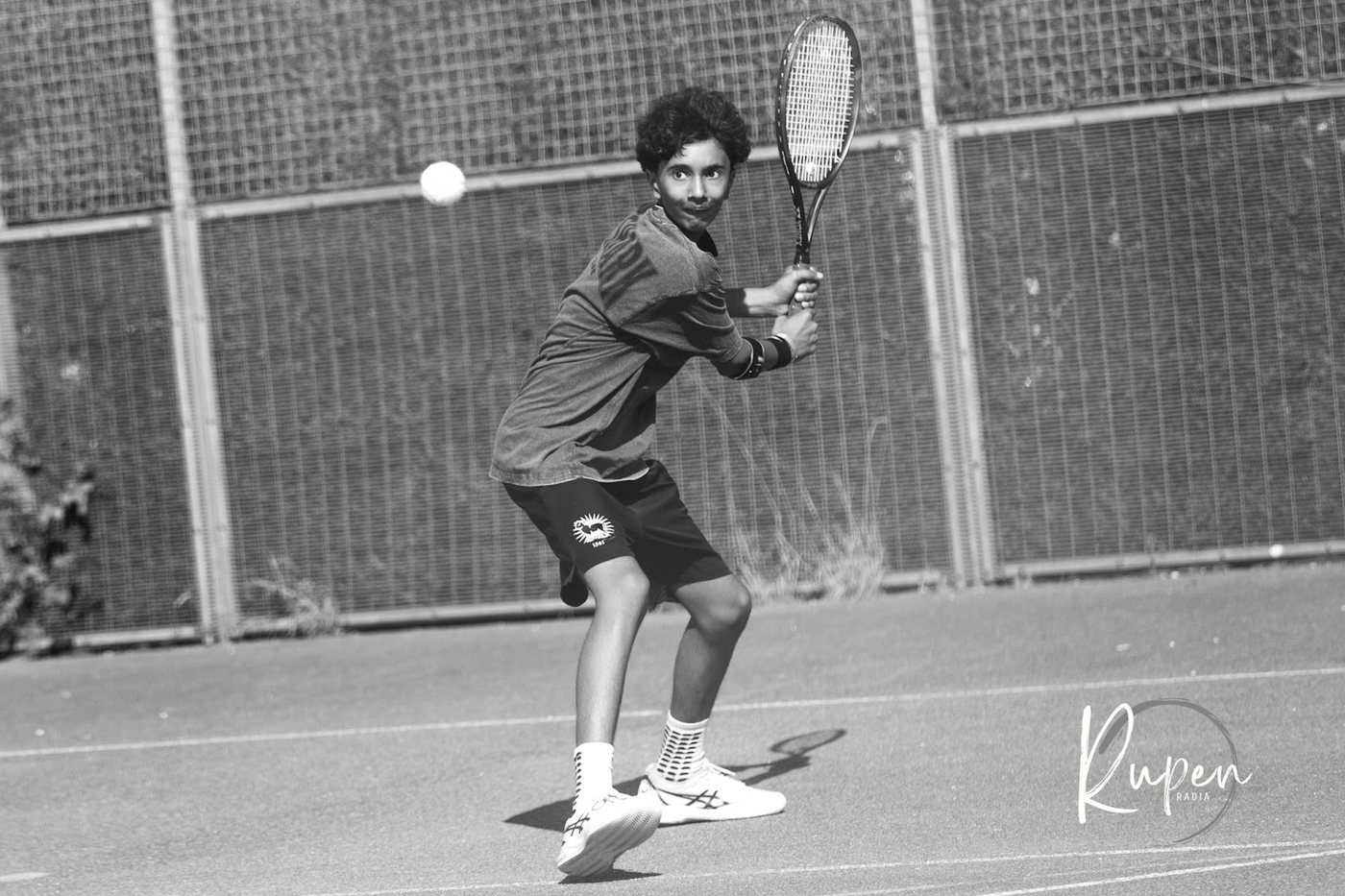 A player preparing to return on the outdoor courts