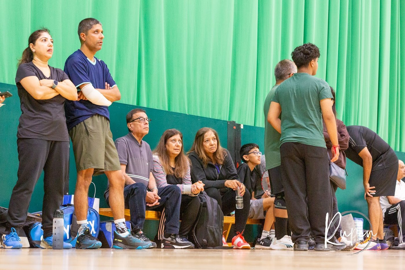 Families and players watching from the side of the hall