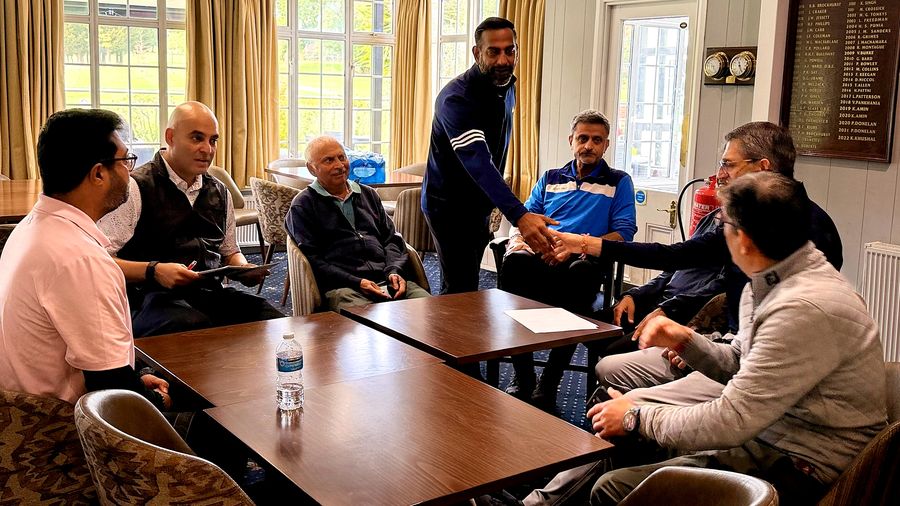 Golfers greeting each other with handshakes as they arrive in the clubhouse at Stanmore Golf Club