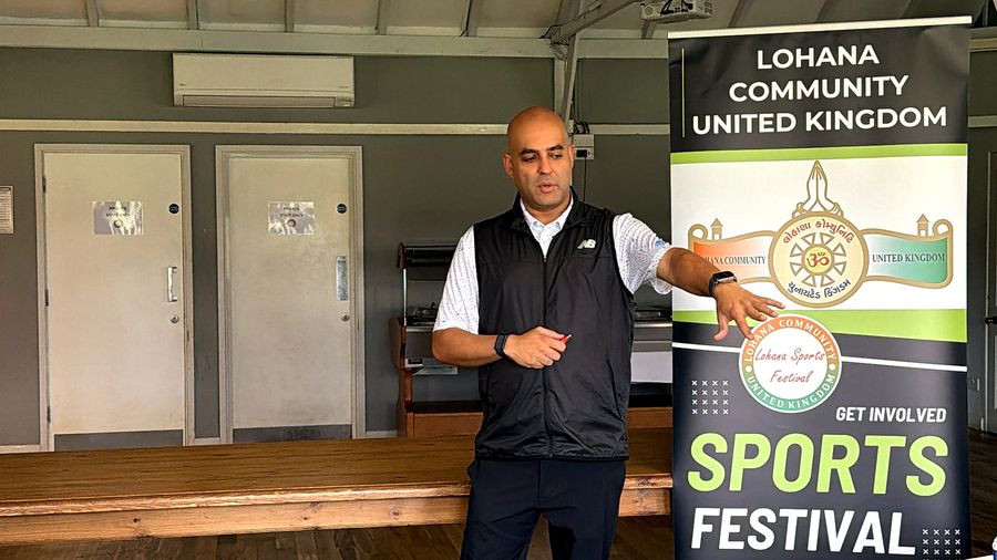 The organiser giving the players' briefing beside the Lohana Sports Festival banner at Stanmore Golf Club