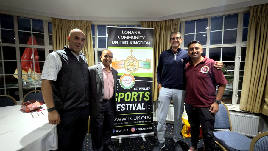 Four members standing together in front of the Lohana Sports Festival banner at the end of the Golf Day presentation