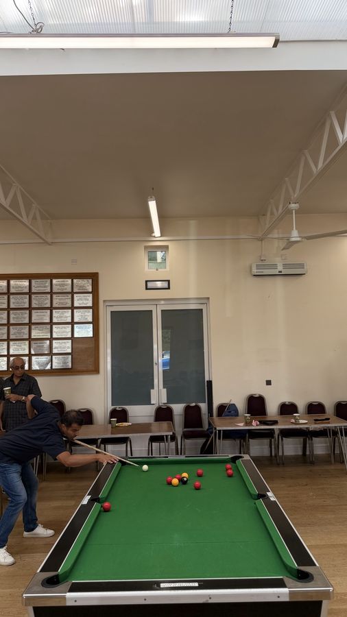 A wide view of the hall at the RCT Centre with pool tables in play and members watching